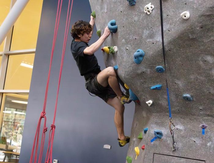 Matthe Menzi carefull places his foot on the hold at the climbing wall